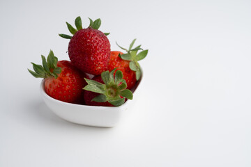 Ripe strawberries on a plate on a light background. Healthy food.
