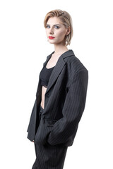 Portrait of a seductive, stylish business lady in the studio. Blonde girl in a suit and top.