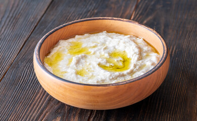Creamy baba ghanoush in wooden bowl with chili and olive oil