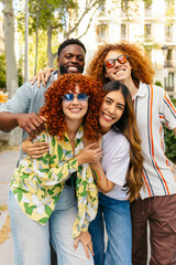 Group of diverse friends embracing in urban setting