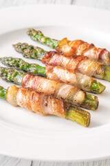 Crispy Fried Asparagus Wrapped In Bacon Served Simply On White Plate
