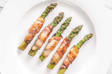 Crispy Fried Asparagus Wrapped In Bacon Served Simply On White Plate