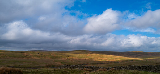 View across the hills at Teesdale with sunlit area on the hills.