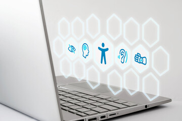 BFSG - Laptop with digital accessibility icons representing visual, auditory, cognitive, and motor impairments. Symbolic image for accessibility, inclusion.