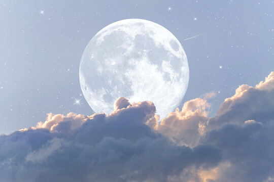 Beautiful blue astrological background with a full moon emerging from clouds with a scattering of stars