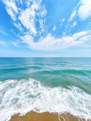 Serene Coastal Scene Ocean Waves Crashing on Sandy Beach Under a Vivid Blue Sky