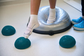 Close-up view of patients feet standing on soft balance pad