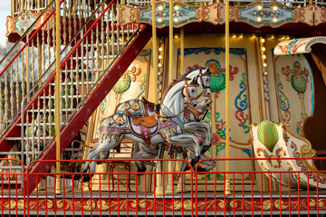 Vintage Carousel Horse with Ornate Decorations Behind Protective Fence