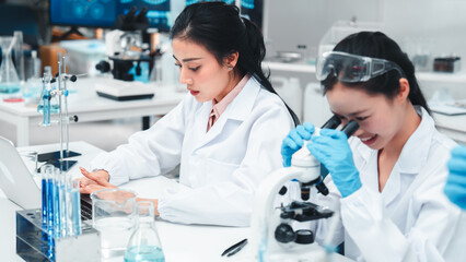Confident female scientist focused on research in a biotechnology lab, symbolizing women...