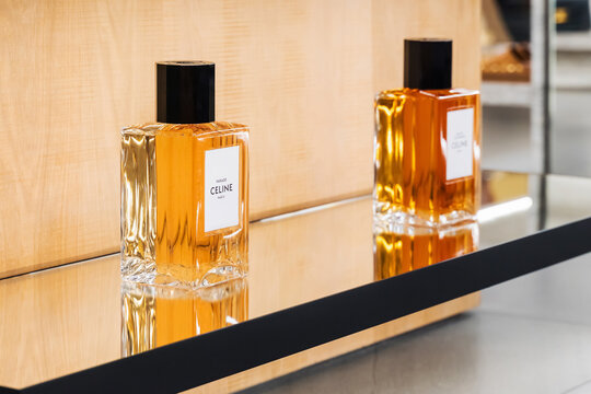 Celine. Two stylish perfume bottles are showcased on a reflective shelf in a contemporary retail environment. China, Shanghai, May 2, 2025