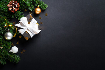 Black christmas background. Christmas present with golden decorations