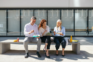 Professionals enjoying a healthy lunch break outdoors