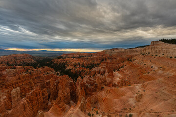 Beautiful cloud movement with contrast and color fills the sky over canyon wilderness, highlighting scenic cliffs, sandstone, dramatic sky, and the natural beauty of a national park landscape.