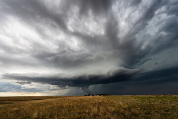 Menacing storm clouds fill the sky, bringing a threatening, dramatic scene with deep shadow, rich texture, and moody atmosphere, showcasing the raw power and beauty of nature’s weather.