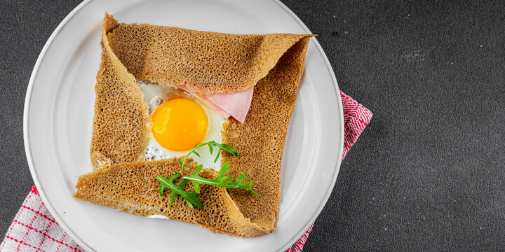 Galette sarrasin fried egg in crepe Breton galette galette complete fresh delicious gourmet food background on the table rustic food top view copy space