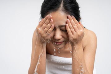 Asian beautiful woman washing her clean face with facial foam and water