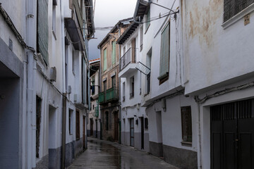 Narrow alley showing traditional whitewashed houses in a spanish town