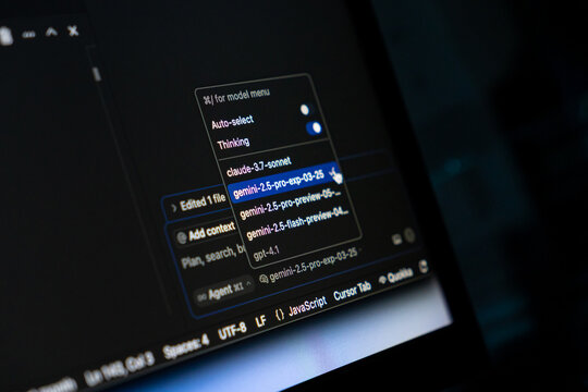 Poznan, Poland - May 15, 2025: AI model selection interface in Cursor application with dropdown showing Gemini, Claude, and GPT options on dark coding workspace screen