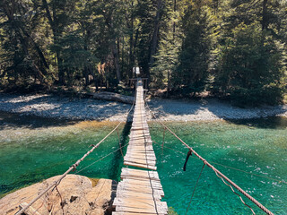 Old wooden bridge crossing the Blue river at El Bolson, Patagonia Argentina.