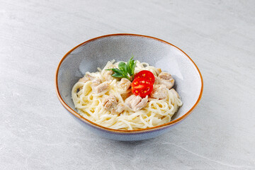 Creamy Chicken Pasta with Cherry Tomato Garnish in Ceramic Bowl
