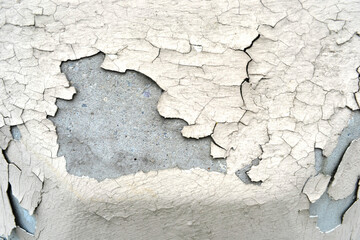 dirty concrete surface with peeling beige paint