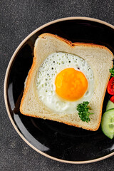Fried gashouse eggs in bread egg in the basket delicious snack breakfast in a bowl fresh delicious gourmet food background on the table rustic food top view copy space