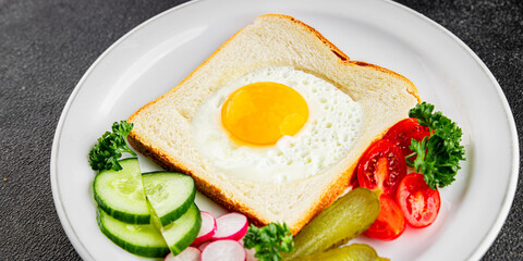 Fried gashouse eggs in bread egg in the basket delicious snack breakfast in a bowl fresh delicious gourmet food background on the table rustic food top view copy space