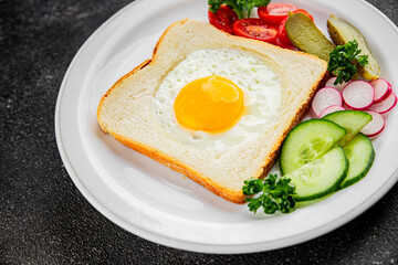 Fried gashouse eggs in bread egg in the basket delicious snack breakfast in a bowl fresh delicious gourmet food background on the table rustic food top view copy space