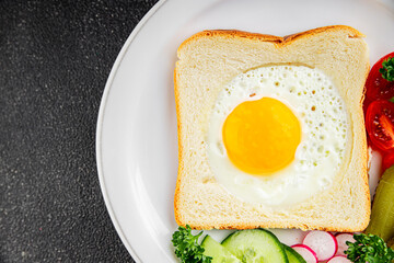 Fototapeta premium Fried gashouse eggs in bread egg in the basket delicious snack breakfast in a bowl fresh delicious gourmet food background on the table rustic food top view copy space