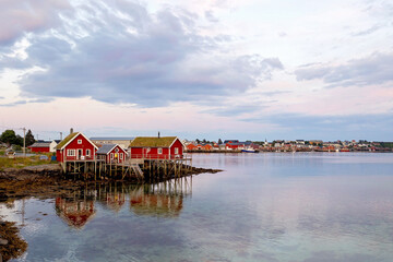 Typical Rourbuer fishing cabins in Lofoten Nusfjord village on a beautiful day, summertime. Traditional norwegian red houses