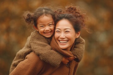 Happy American mother having fun with her daughter outdoor - Family people and love concept - Focus on mum face 