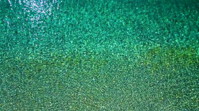 Top-down view of sea azure waves pattern and crystal clear water. Rhodes, Greece