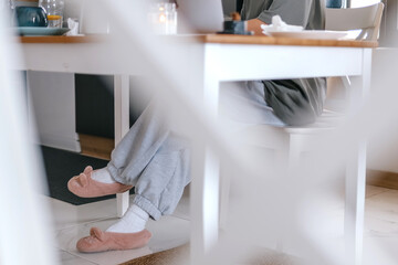  Gen Z woman working from home at cozy kitchen table with laptop and phone. Digital nomad lifestyle, mindfulness, remote work, balance, mental calm and modern freelancing