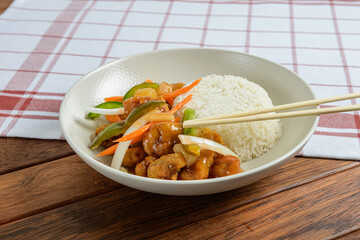 Flavorful Chicken Stir-Fry Served With Steamed Rice on a Rustic Wooden Table at a Cozy Home Kitchen