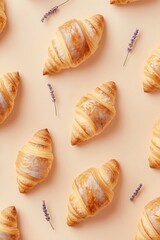 Handmade croissants with lavender sprigs on soft linen surface, top view. Fresh baked pastry