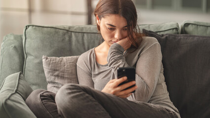 Young woman spends all her time on her mobile phone