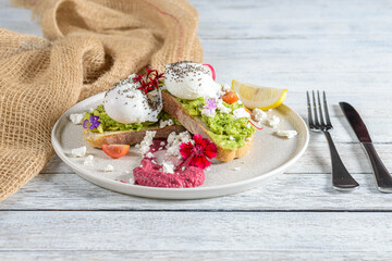 Delicious Brunch Spread Featuring Avocado Toast With Poached Eggs, Vibrant Toppings, and a Touch of Elegance on a Rustic Table
