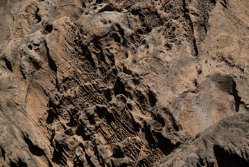 Background of rough volcanic rock texture creating natural earth tone background