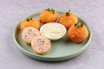 Golden Chicken Rice Croquettes with Herb Mayo Dip on Green Plate