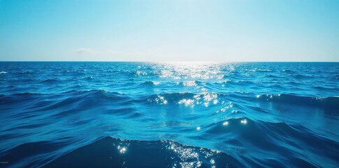 Vast expanse of deep blue ocean water, sunlit surface with gentle waves creating a tranquil and serene seascape  Perfect for travel, nature, or environmental themes , sunlight, tranquil, beach