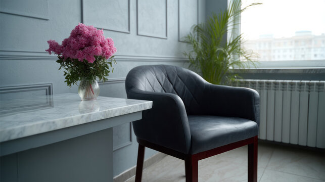 A plush grey armchair cozily nestles beside pink blossoms, creating a serene feng shui vibe perfect for Hygge Day