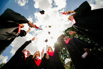 Low ange view photo of groupmates studentsthrowing air mortarboard graduate college outdoors