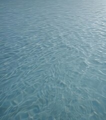 Subtle ripples on a serene, light blue water surface  ,  gentle,  movement,  light