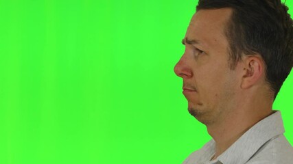 Side-to-front turning motion of a man showing exaggerated skepticism or disapproval, captured on green screen for expressive emotional content. Suitable for critical or humorous themes.