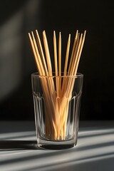 Neat toothpicks in a glass under soft light