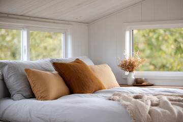 Fototapeta premium bright and cozy bedroom in tiny house featuring minimalist decor and soft natural light