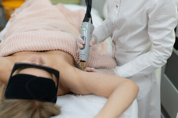 A client receives professional laser hair removal treatment
