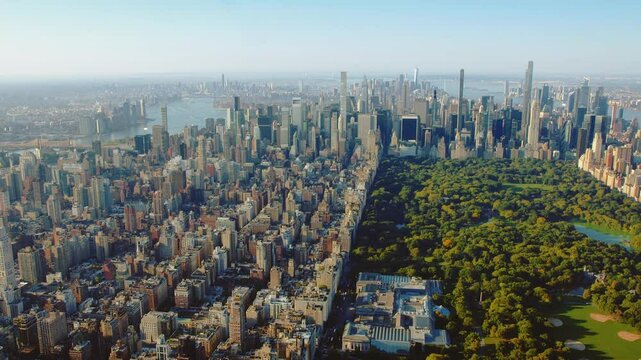 Aerial Overview Of Central Park, Midtown Manhattan Skyline. Billionaires Row, New York City. Serene Water Bodies And Natural And Architectural Beauty. High Quality Content Shot from Helicopter.