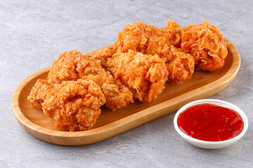 Crispy Fried Chicken Bites with Sweet Chili Dip on Bamboo Plate