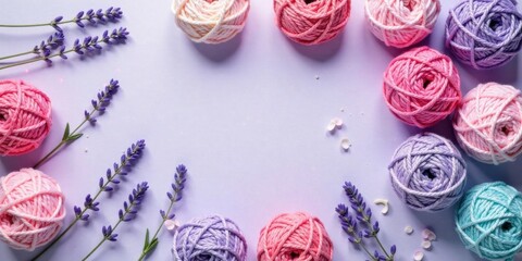Pastel yarn balls and lavender flowers arranged artistically on a light purple background, creating a charming and delicate scene perfect for crafting projects or springtime themes.